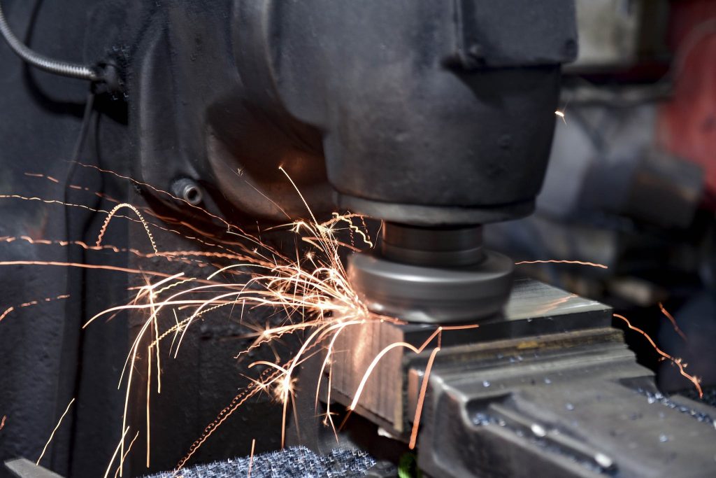 A machine is grinding sparks on a metal surface